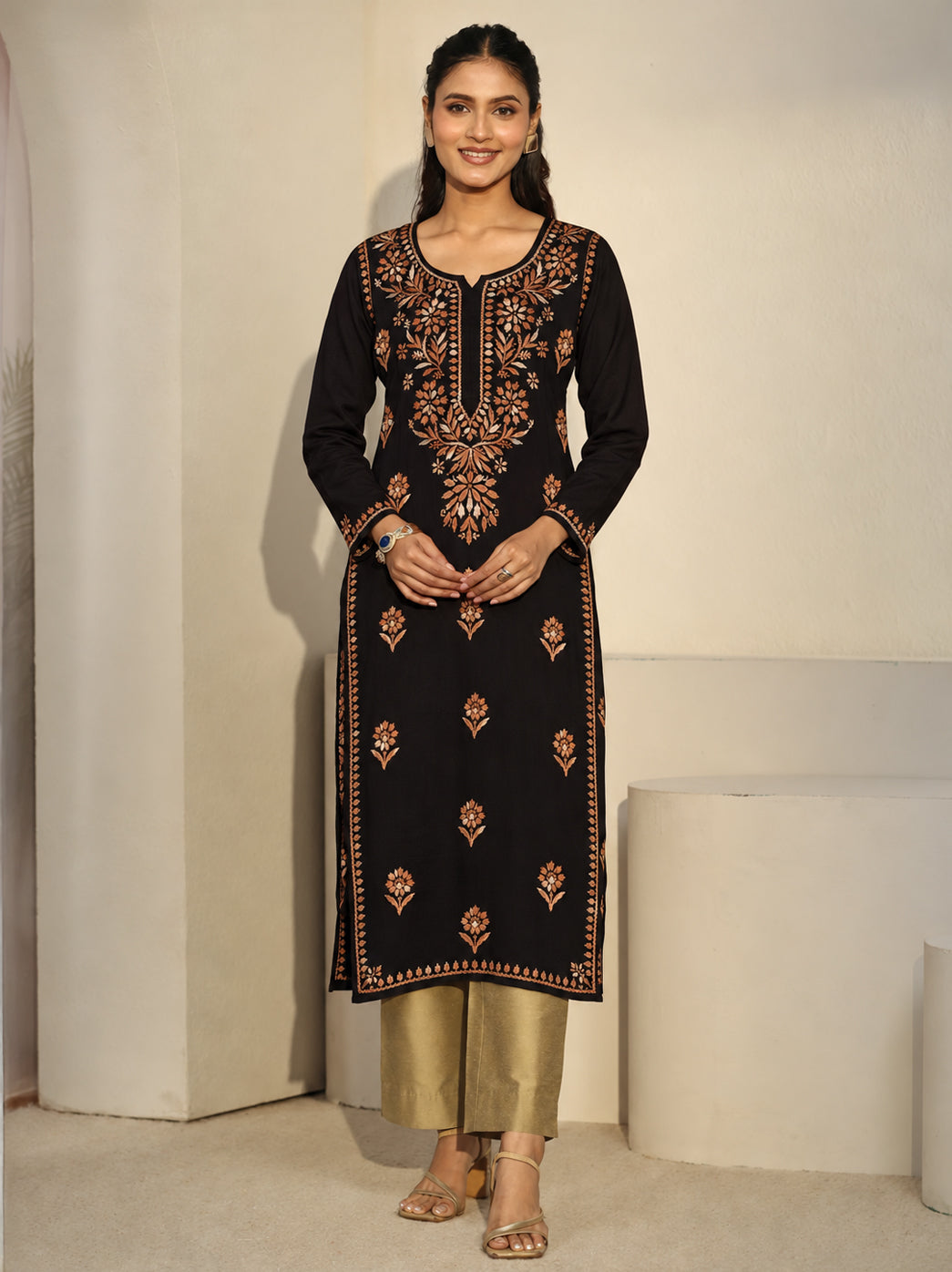 Long rayon straight kurti styled with wide-leg denim and open-toe sandals, featuring Chikankari floral embroidery that extends from the neckline down the centre of the upper front.