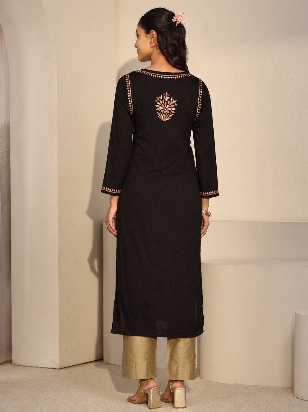 Front view of the Ayra Rayon Straight Kurti by The Chikan Label, displaying a decorative floral neckline panel, evenly spaced botanical motifs and embroidered detailing along the cuffs and hem.