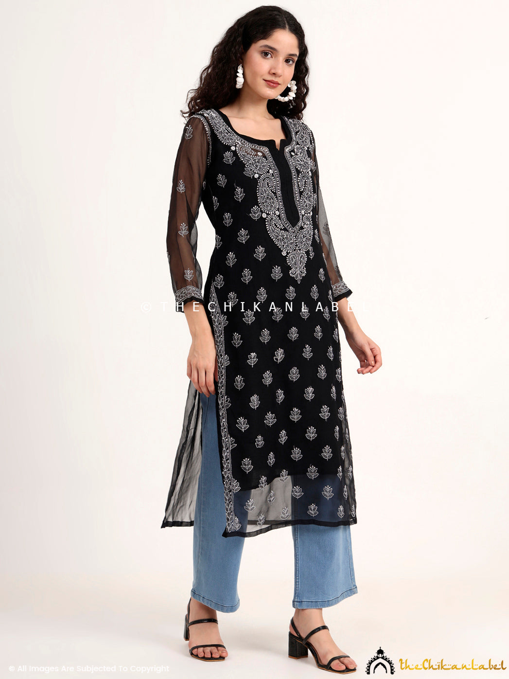 Model in a black georgette chikankari kurti with sheer sleeves and a straight-cut design, exuding sophistication and handcrafted charm.