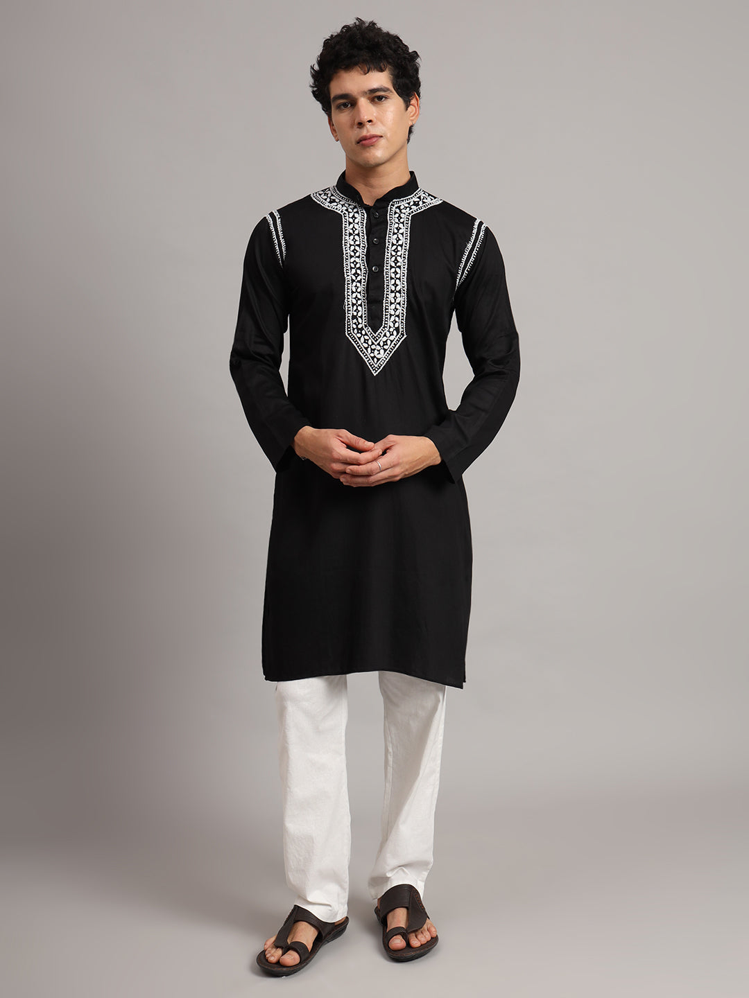 Uman Mens Kurta featuring Chikankari embroidery around the mandarin collar and button placket, styled with straight trousers and sandals for a classic ethnic look.