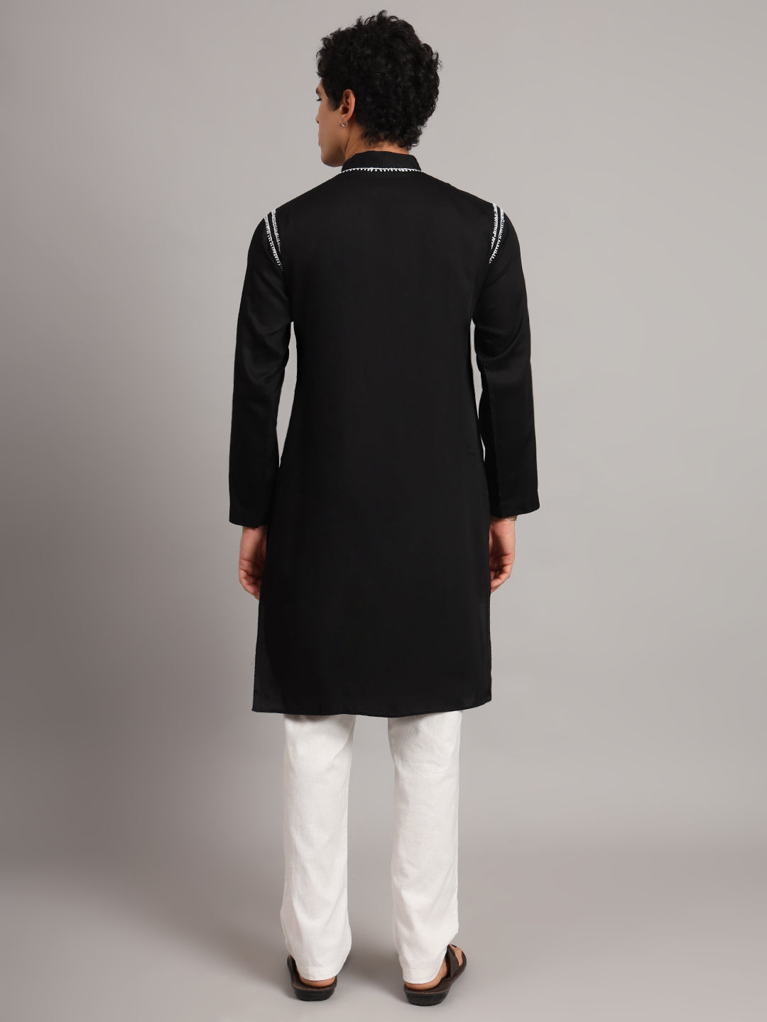 Male model wearing the Uman Mens Kurta with detailed Chikankari embroidery along the neckline and shoulders, paired with trousers for everyday ethnic styling.