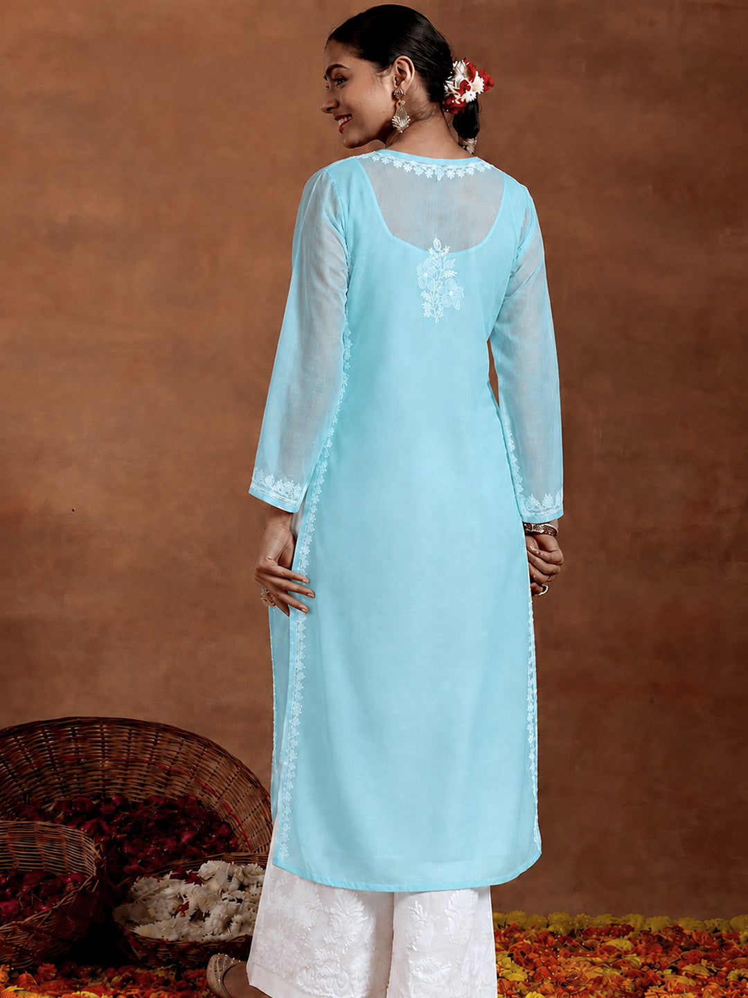 Comfortable regular wear kurta with intricate Chikankari floral embroidery, breathable cotton fabric, three-quarter sleeves and straight silhouette for women.