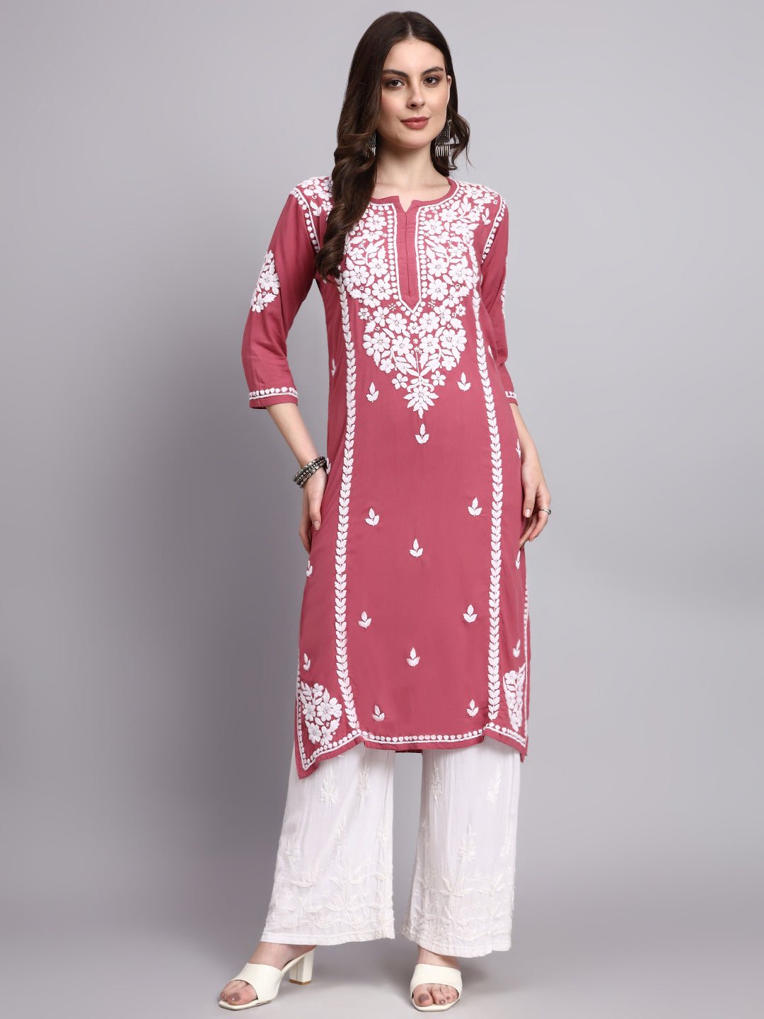Woman wearing a rayon chikankari long kurta featuring handcrafted floral embroidery with straight fit silhouette and elegant neckline design