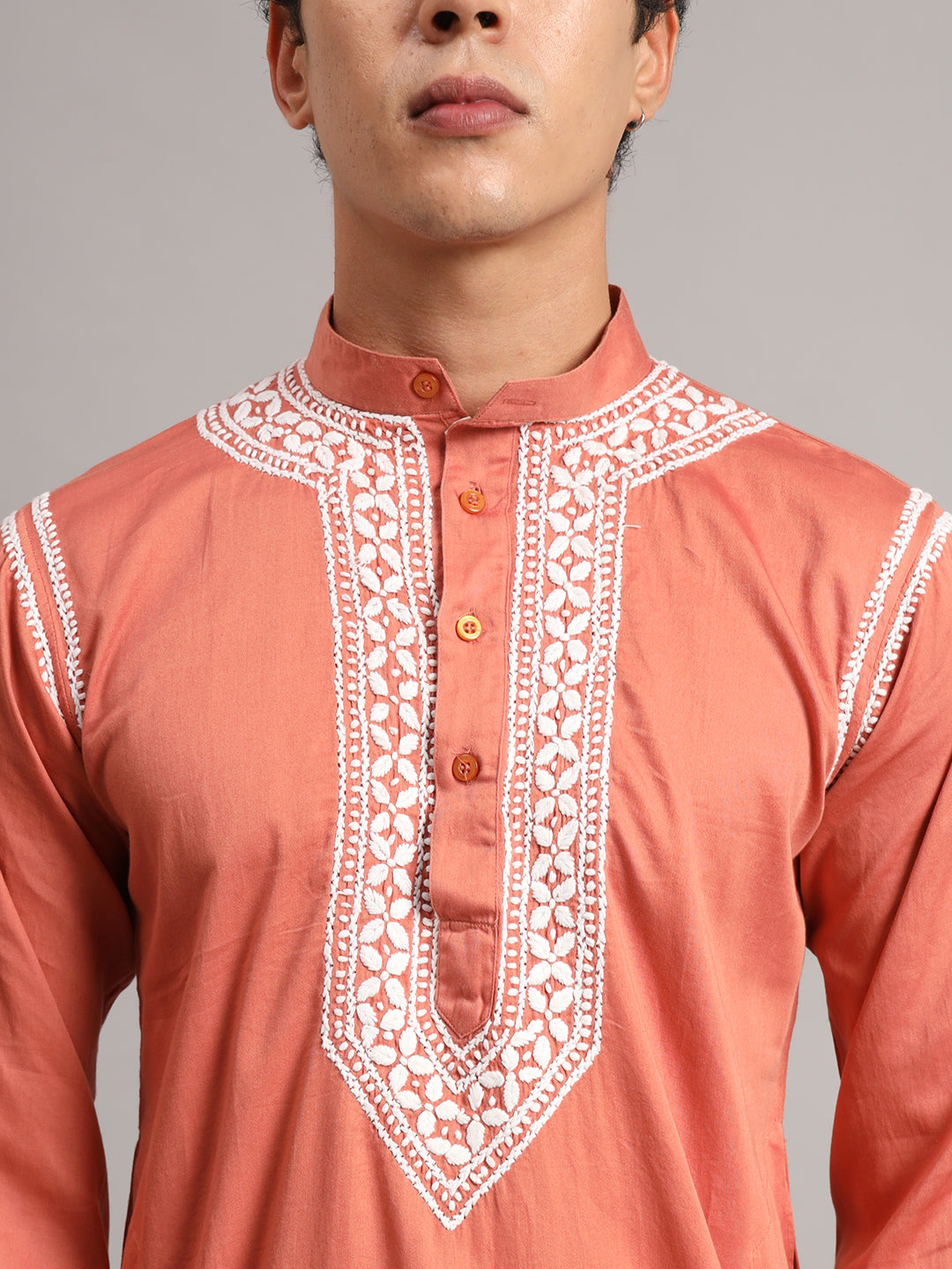 Uman Mens Kurta styled for a regular wear ethnic look, featuring full sleeves, a straight cut and decorative Chikankari embroidery concentrated around the neckline.