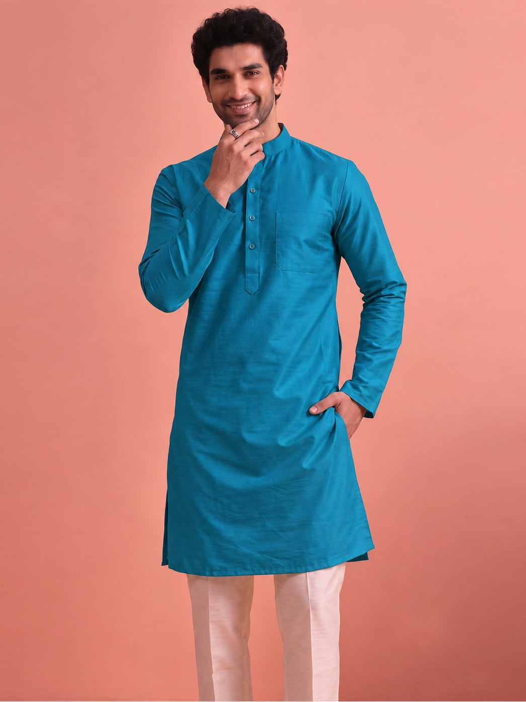 Minimalist men’s straight kurta featuring a clean cotton construction, full sleeves, Mandarin collar, front button placket, chest pocket, and versatile regular fit for contemporary ethnic fashion
