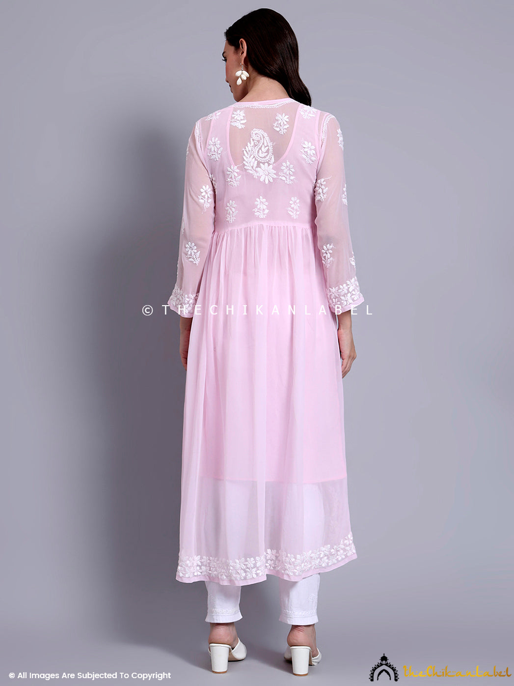 Traditional georgette A-line kurti styled for festive wear with delicate chikankari detailing on sleeves, yoke, and hem.

