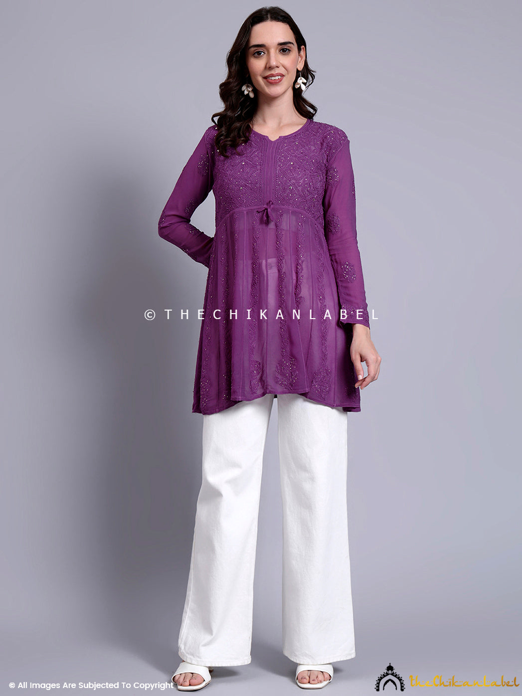 Artisan-crafted chikankari peplum top with flared silhouette, perfect for ethnic and casual outings.

