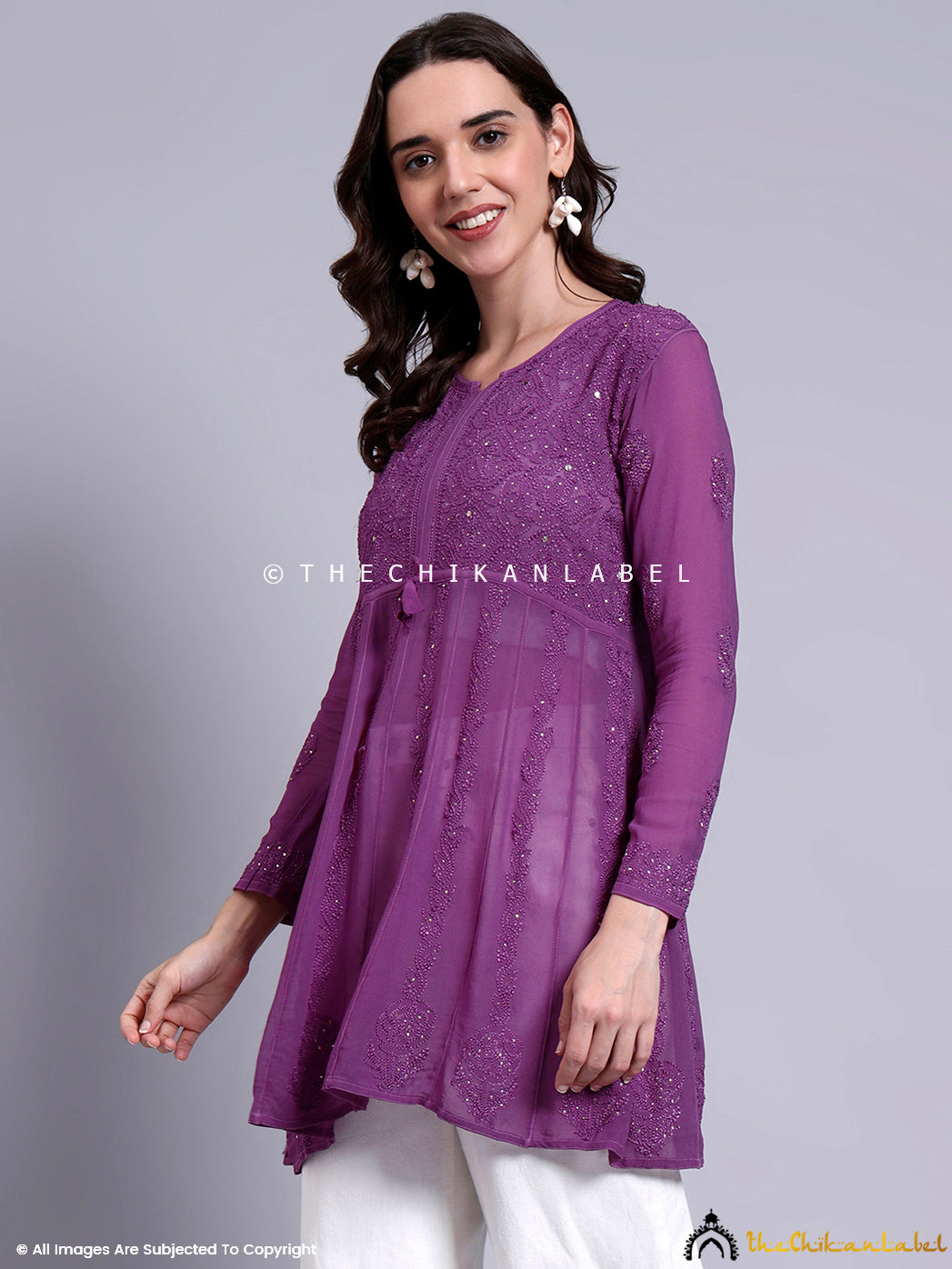Long-sleeved chikankari peplum top made from breathable viscose material with front yoke detailing.

