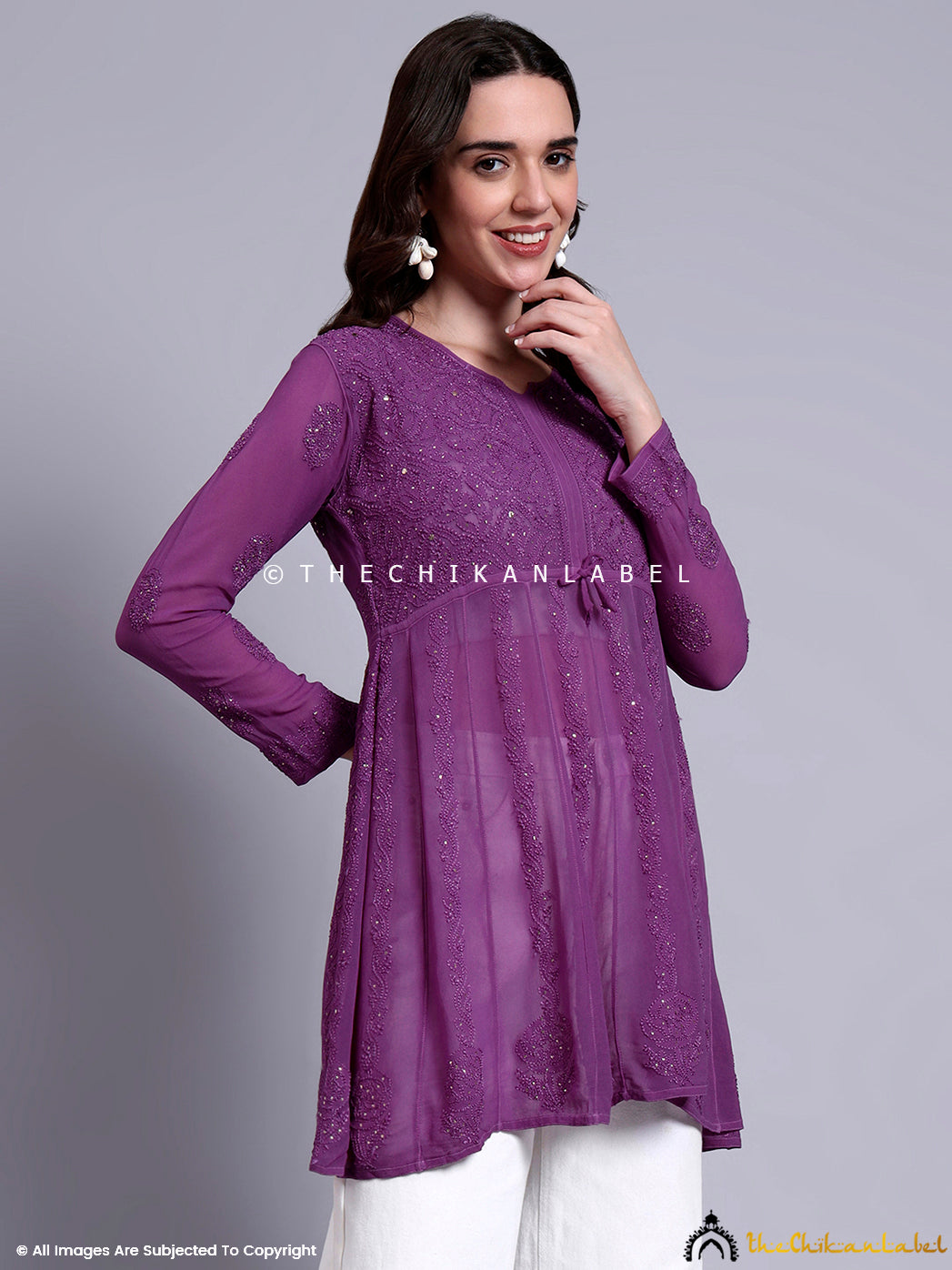 Trendy chikankari peplum top paired with jeans, showcasing elegant embroidery and flare.

