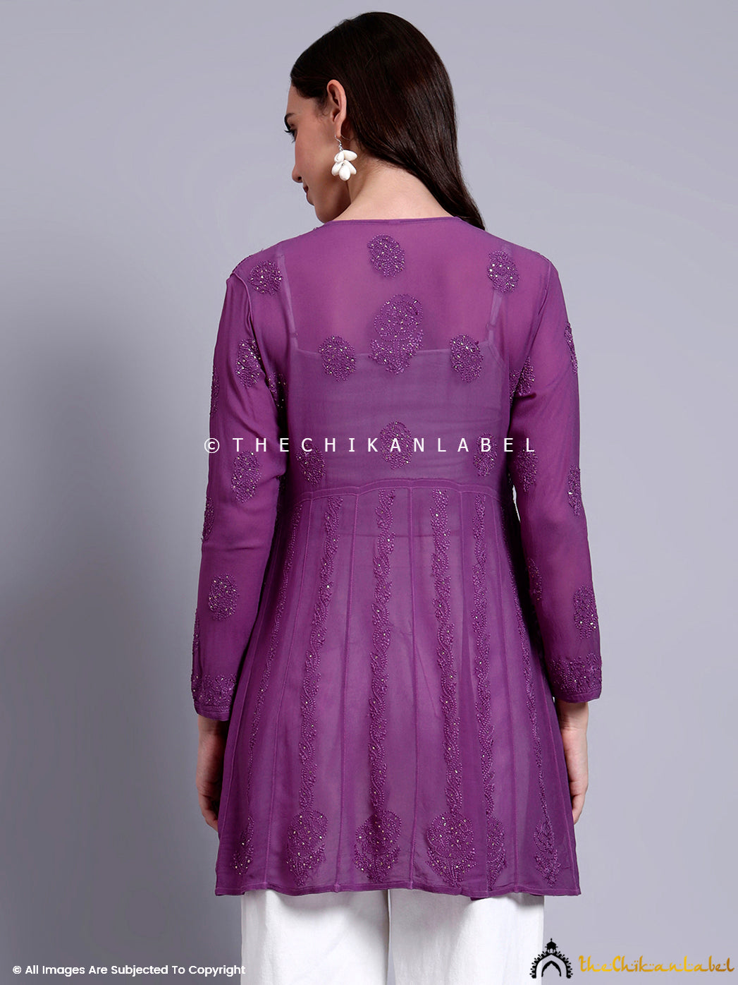 Stylish peplum top designed with detailed floral chikankari and delicate mirror embellishments for a festive look.


