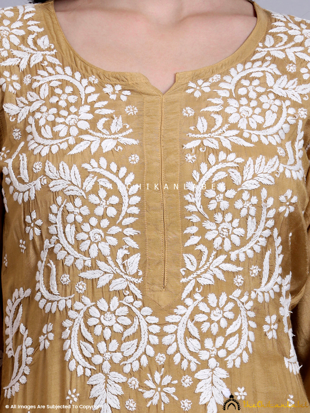 Traditional muslin kurti featuring full sleeves and artisan-made chikankari patterns near the hem.

