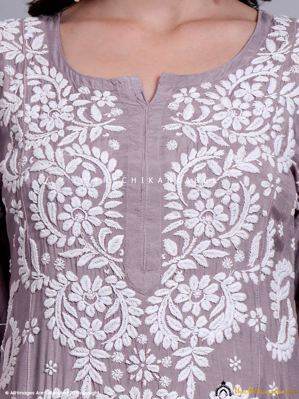 Graceful Indian ethnicwear showcasing hand-embroidered straight kurti made with sustainable muslin.

