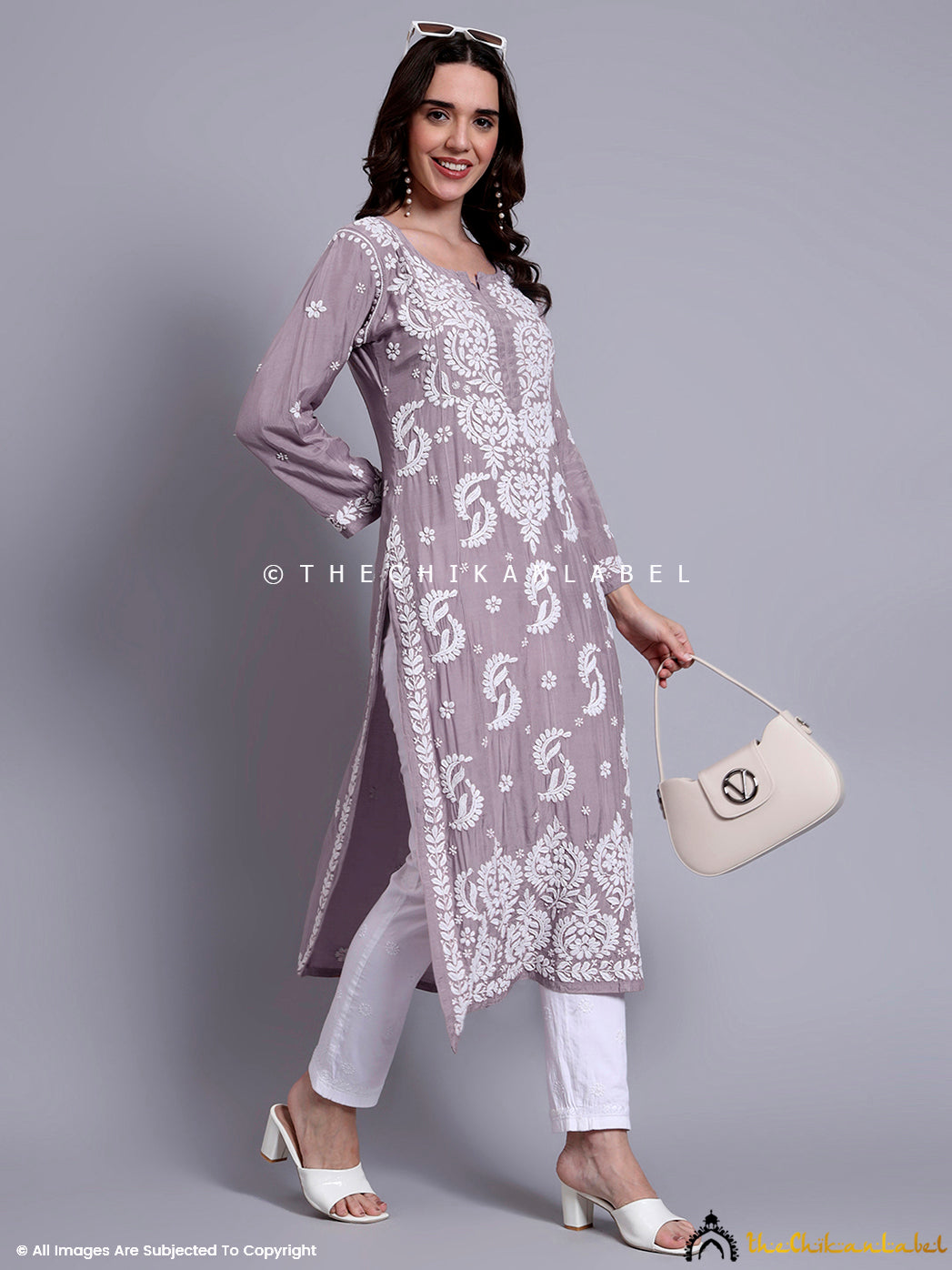 Rear view of muslin chikankari kurti showcasing the fluid drape and neat tailoring.

