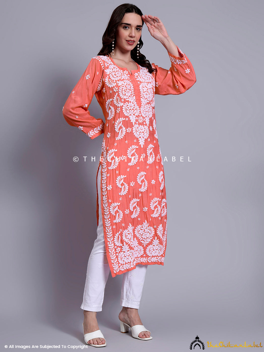 Zoomed-in embroidery view of muslin chikankari kurti focusing on neckline and sleeve detailing.

