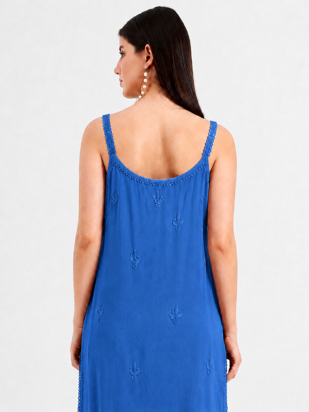 Esha Viscose Short Strappy Kurti styled with wide-leg jeans, featuring detailed embroidery and a feminine sleeveless neckline for contemporary casual fashion.