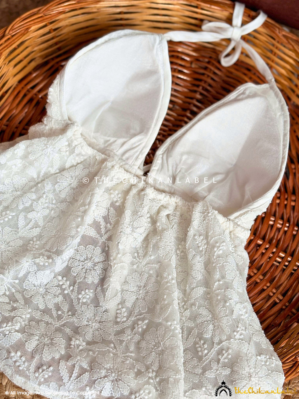 Stylish resort wear top designed with intricate hand embroidery ideal for tropical destinations.

