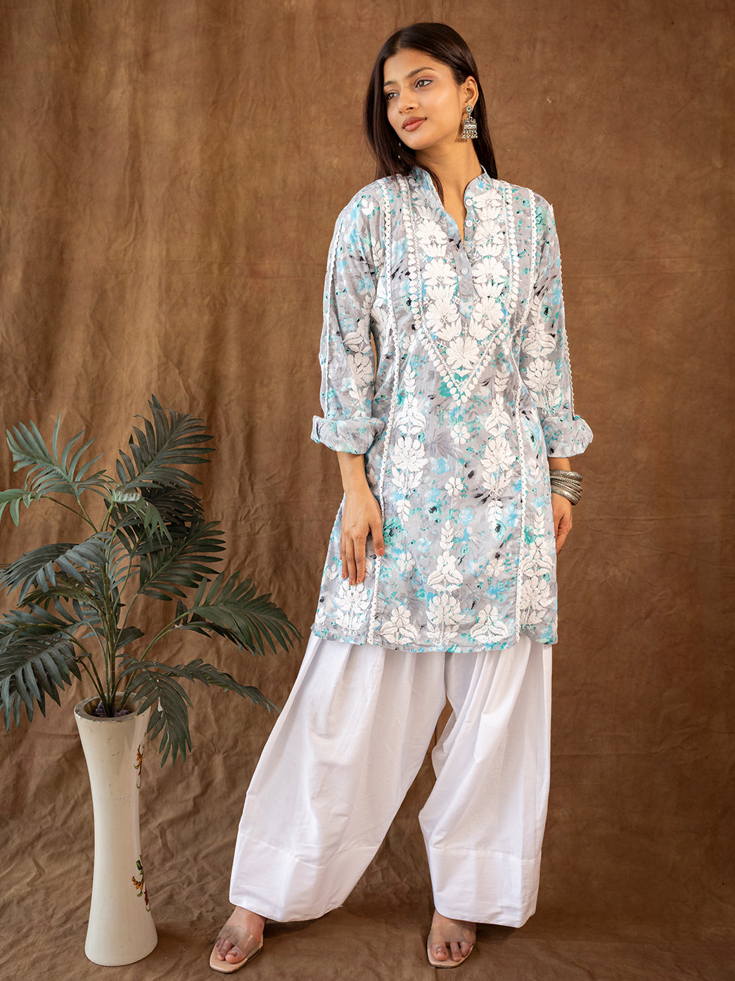 Mulmul chikankari kurta paired with farshi salwar, featuring intricate hand embroidered floral patterns inspired by traditional Lucknow craftsmanship