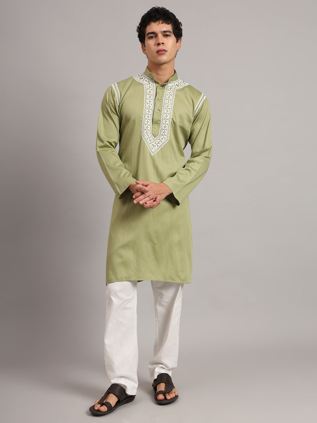 Uman Mens Kurta featuring Chikankari embroidery around the mandarin collar and button placket, styled with straight trousers and sandals for a classic ethnic look.