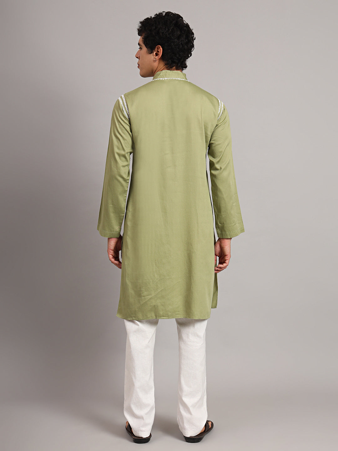Male model wearing the Uman Mens Kurta with detailed Chikankari embroidery along the neckline and shoulders, paired with trousers for everyday ethnic styling.