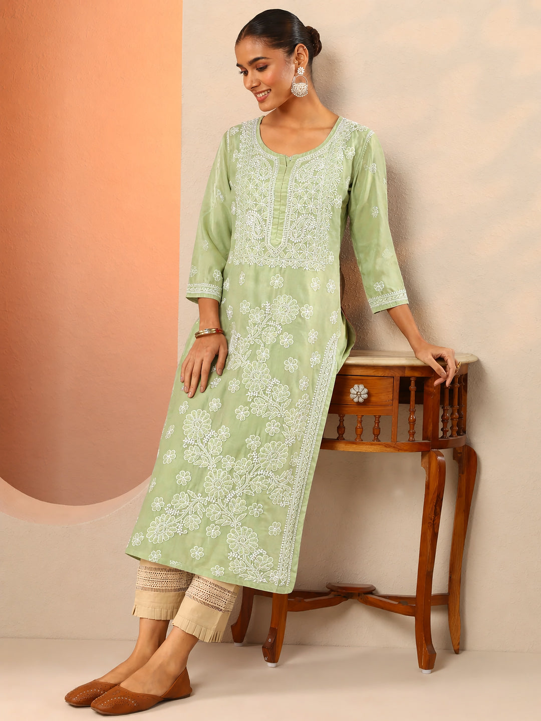 Women wearing cotton straight kurti with intricate chikankari embroidery in a comfortable regular wear ethnic outfit