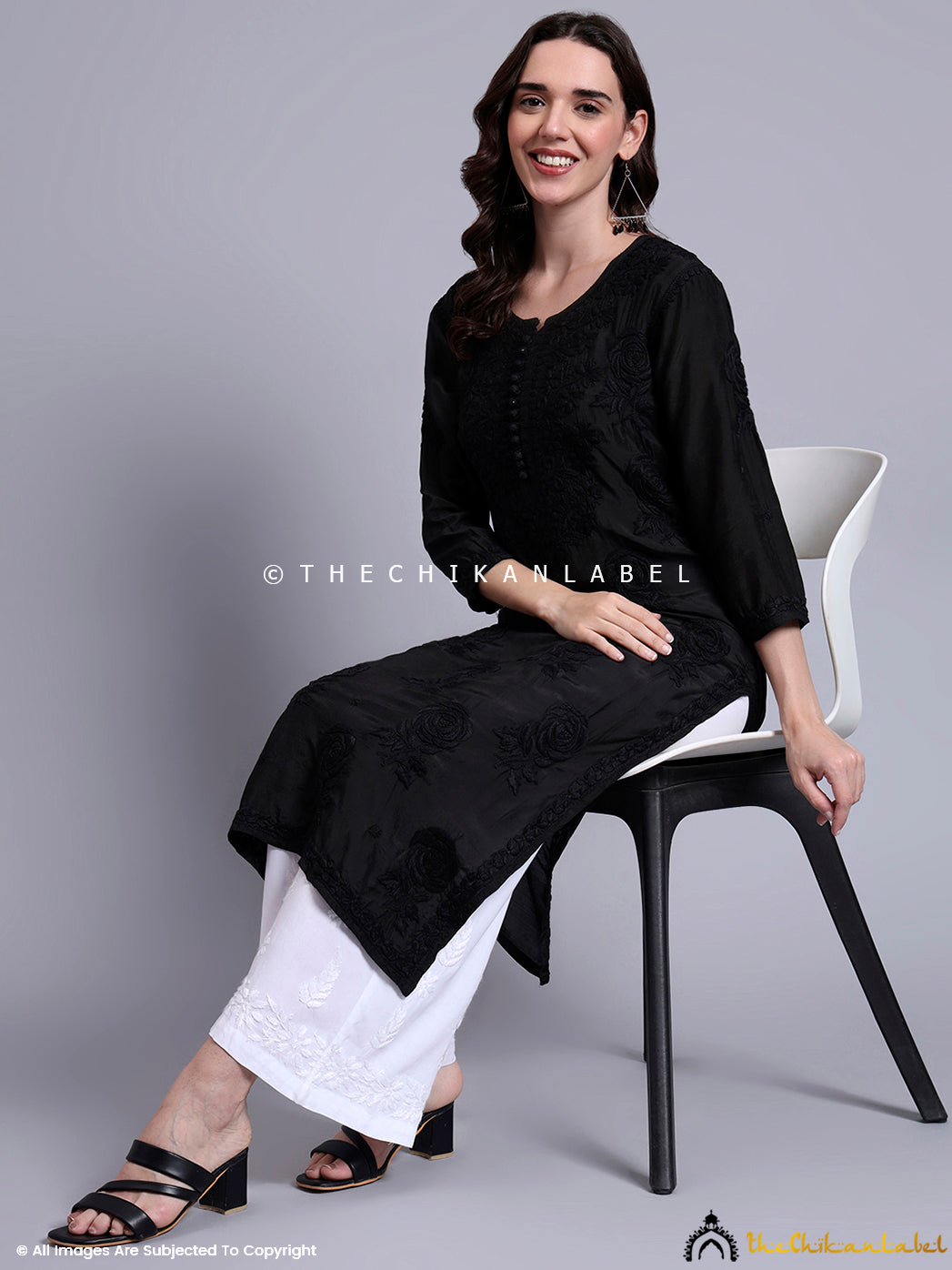 Model dressed in a muslin chikankari straight kurti with tonal threadwork and subtle rose motifs, perfect for modern Indian ethnicwear lovers.

