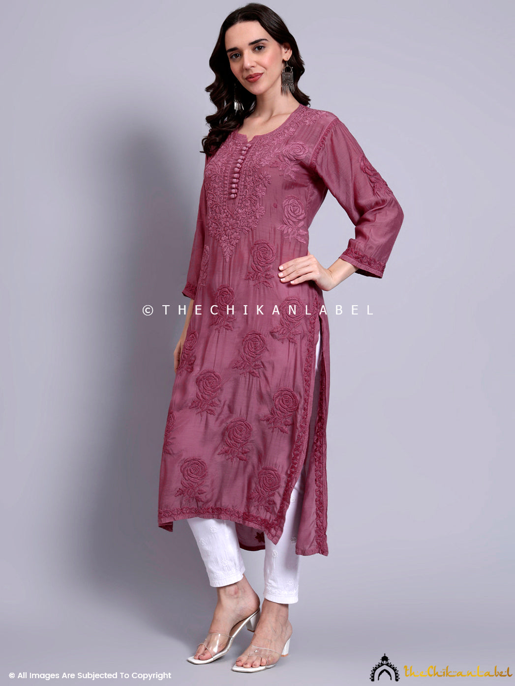 Full-length image of model in muslin kurti adorned with traditional Lucknowi chikankari floral motifs and three-quarter sleeves, styled with minimal accessories.

