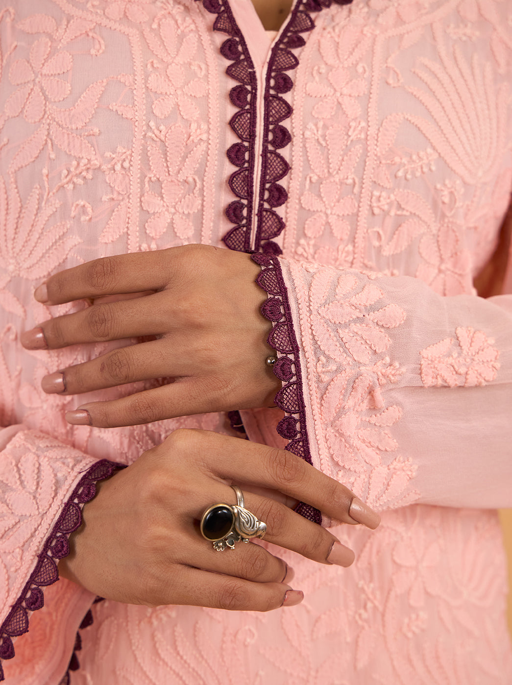 Gulnaar Chikankari kurti featuring a narrow lace-trimmed neckline opening, surrounded by intricate floral threadwork on the embroidered front panel.