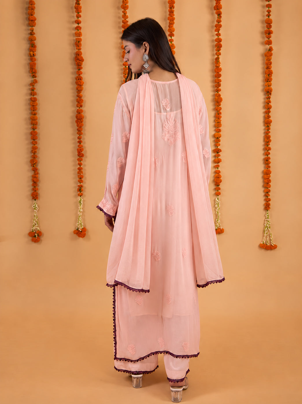 Full-length model photograph of the Gulnaar Chikankari set, capturing the kurti’s botanical embroidery and decorative lace at the ankle-length hem.