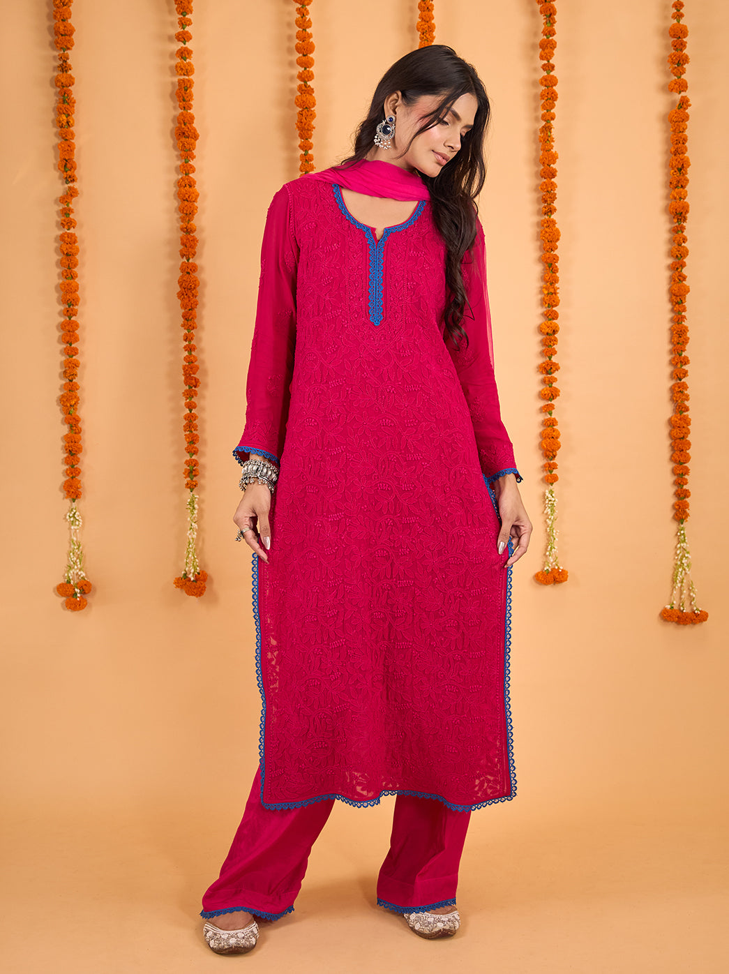 Model wearing the Gulnaar Viscose Straight Kurti Palazzo Set with Dupatta, showcasing intricate floral Chikankari embroidery framed by scalloped neckline lace.