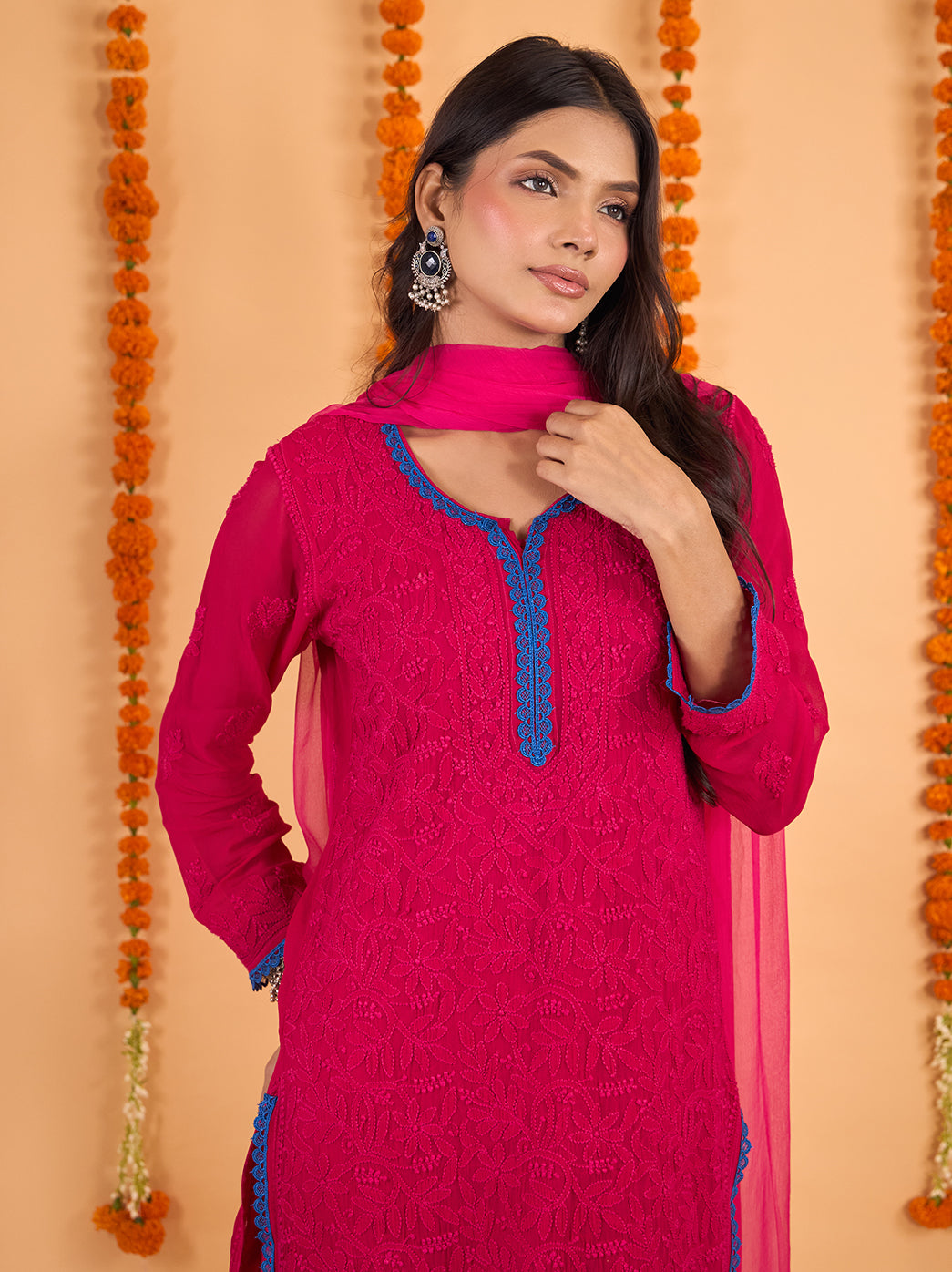 Model posing with one arm raised to display the Gulnaar kurti’s embroidered sleeve, decorative lace cuff and softly draped viscose fabric.