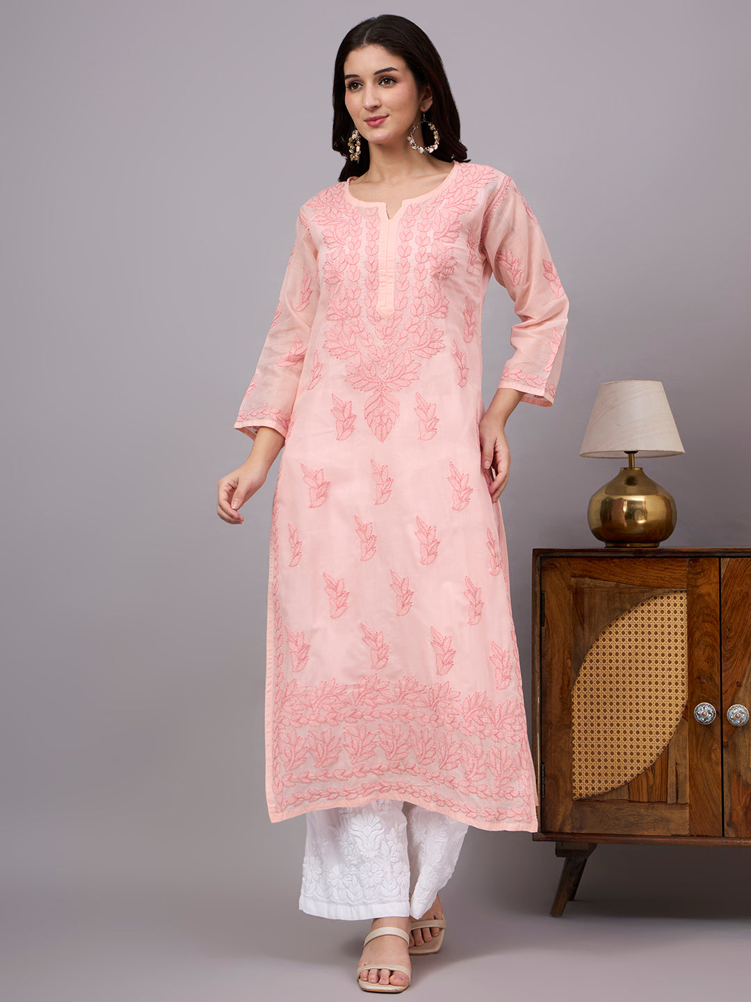 Women's trending kurti featuring handcrafted Lucknow Chikankari embroidery, premium cotton construction, soft inner lining, and elegant straight-fit styling.