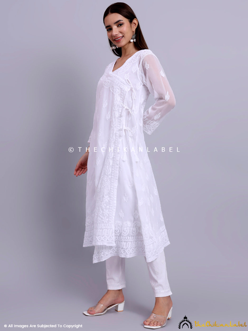 Artisanal chikankari angrakha with fine embroidery details, paired with churidar pants and heels.


