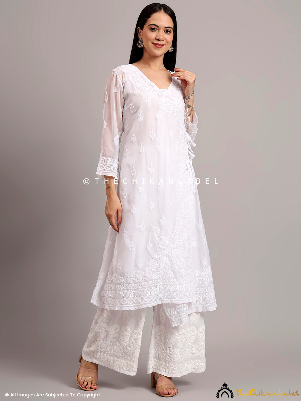 Asymmetrical Angrakha kurta crafted in georgette, with wrap-around detailing and light embroidery perfect for summer dressing

