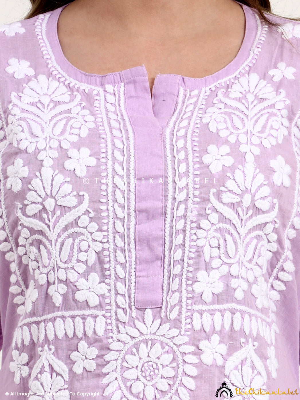 Hand-embroidered chikankari kurta set crafted from breathable khadi cotton fabric with intricate floral motifs.