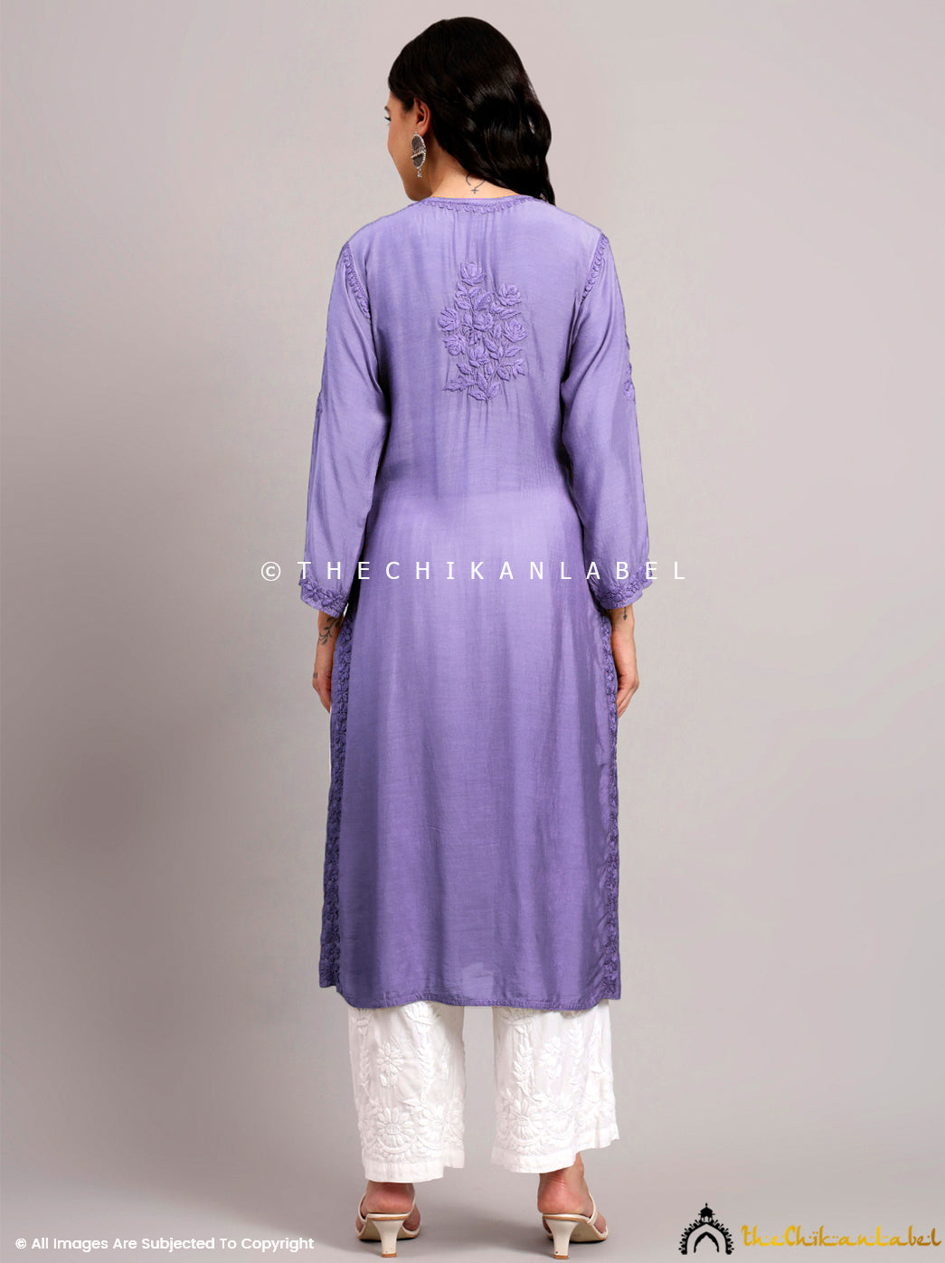 Timeless muslin chikankari kurti with round neckline, handcrafted button details, and aligned floral motifs for classic ethnic fashion.

