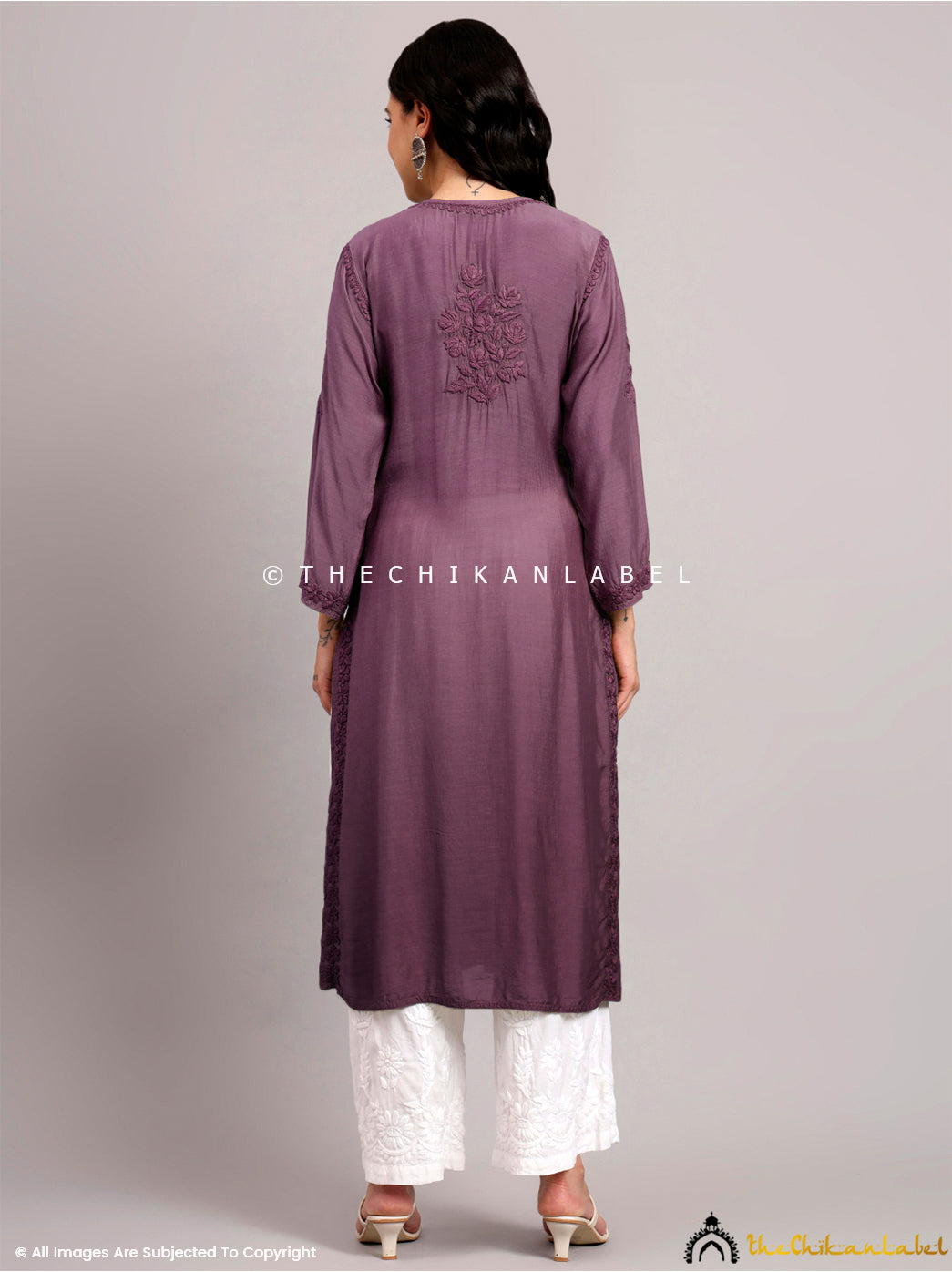 Elegant handcrafted kurti design with traditional floral chikankari embroidery patterns on a muslin base, styled for everyday wear.

