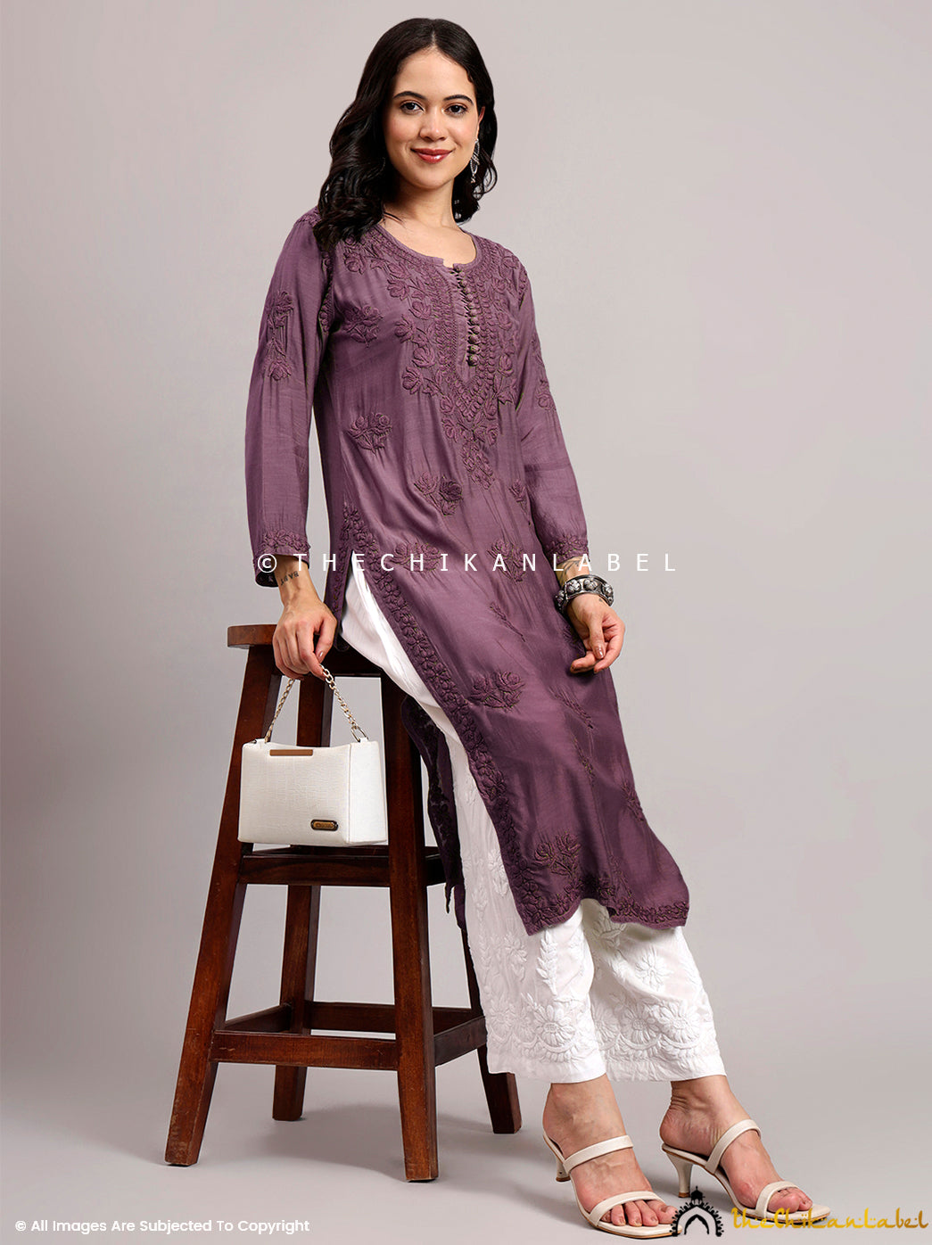 Hand-embroidered muslin chikankari kurti with 3/4th sleeves and intricate threadwork ideal for workwear and festive styling.

