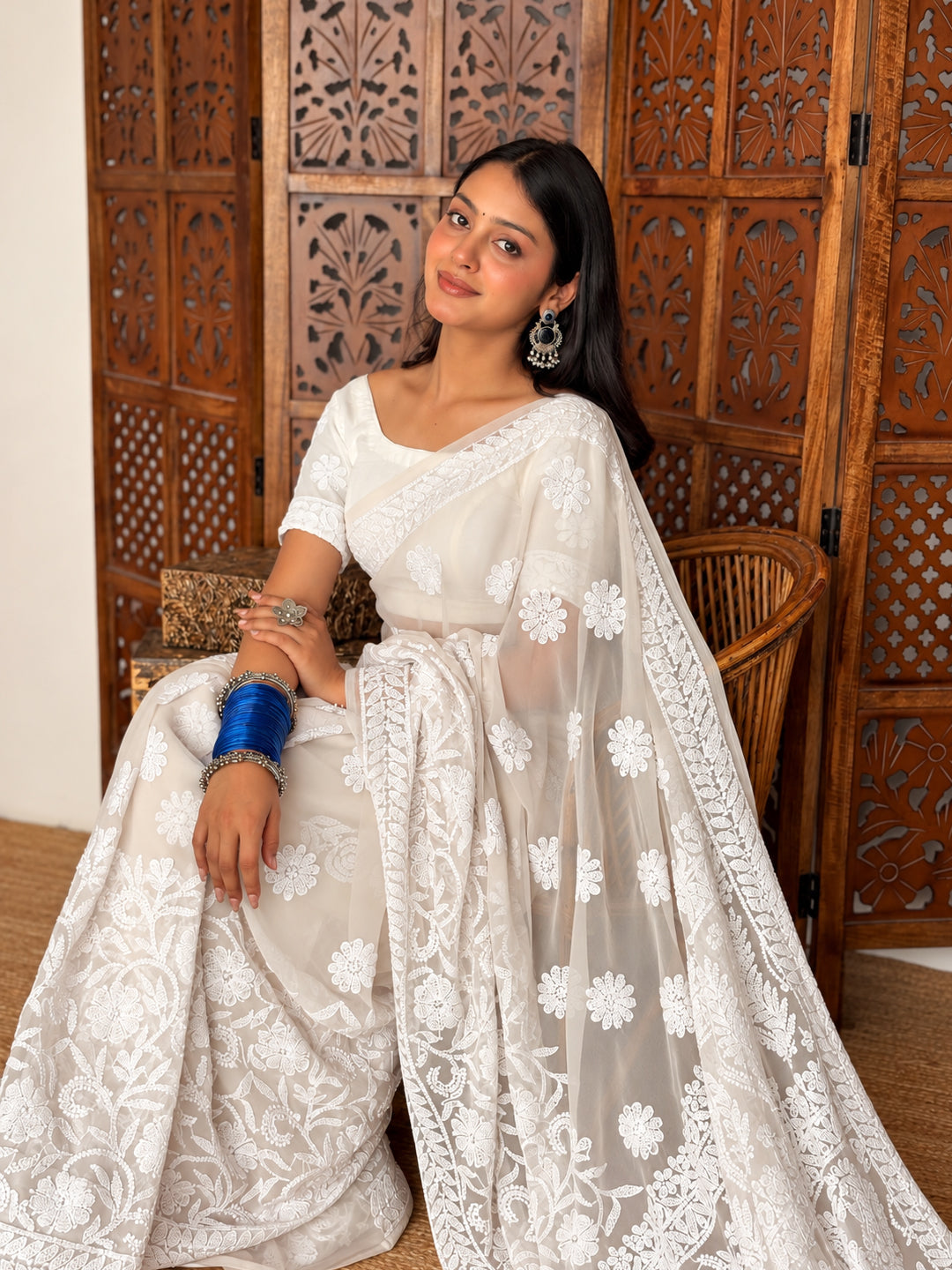 Front view of a model in the Kiana Chikankari saree, displaying scattered flower motifs across the drape and paisley embroidery on the pallu.