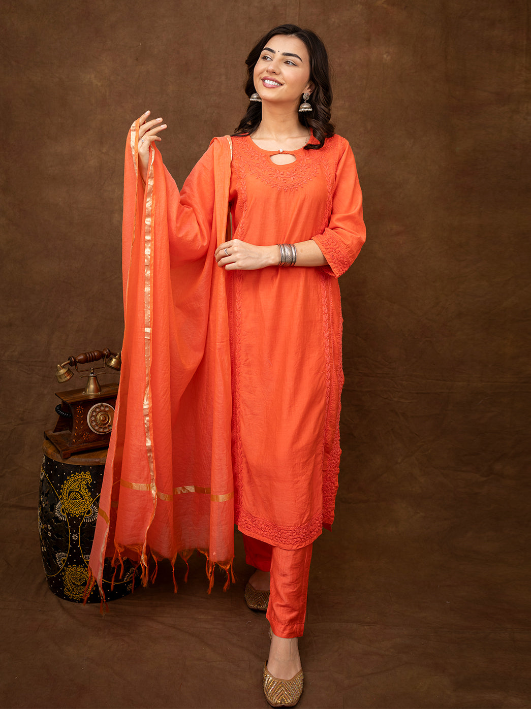 Woman wearing Kriti Chanderi chikankari kurta set with dupatta featuring intricate hand embroidery and straight silhouette for festive wear