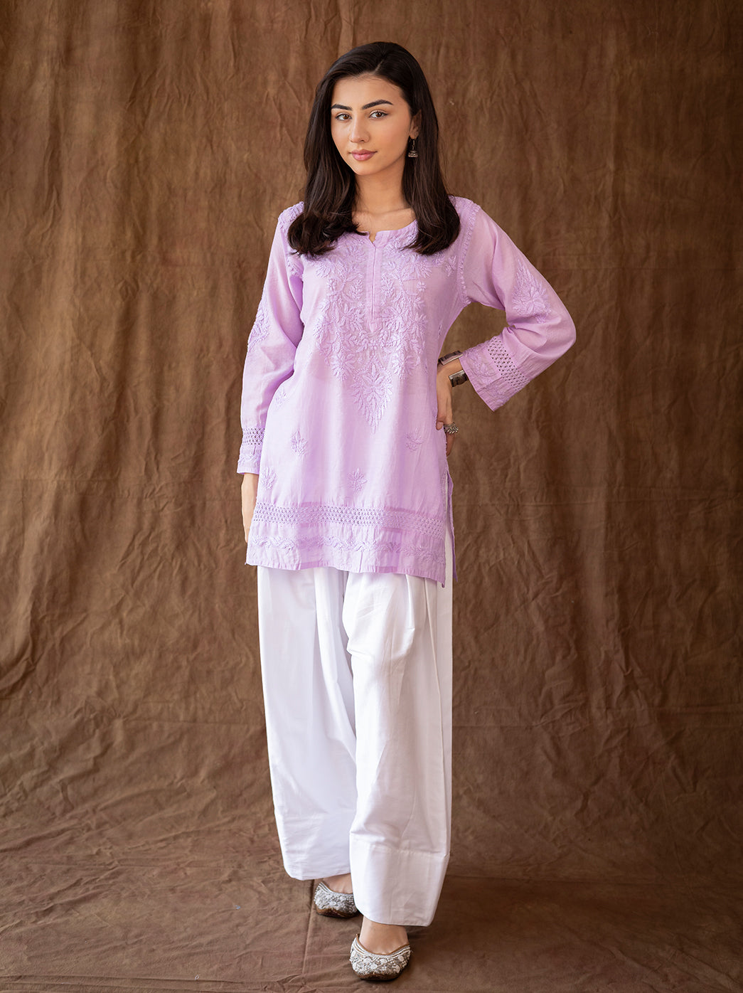 Handcrafted chikankari kurti with intricate embroidery across the neckline and hem, styled with classic farshi salwar
