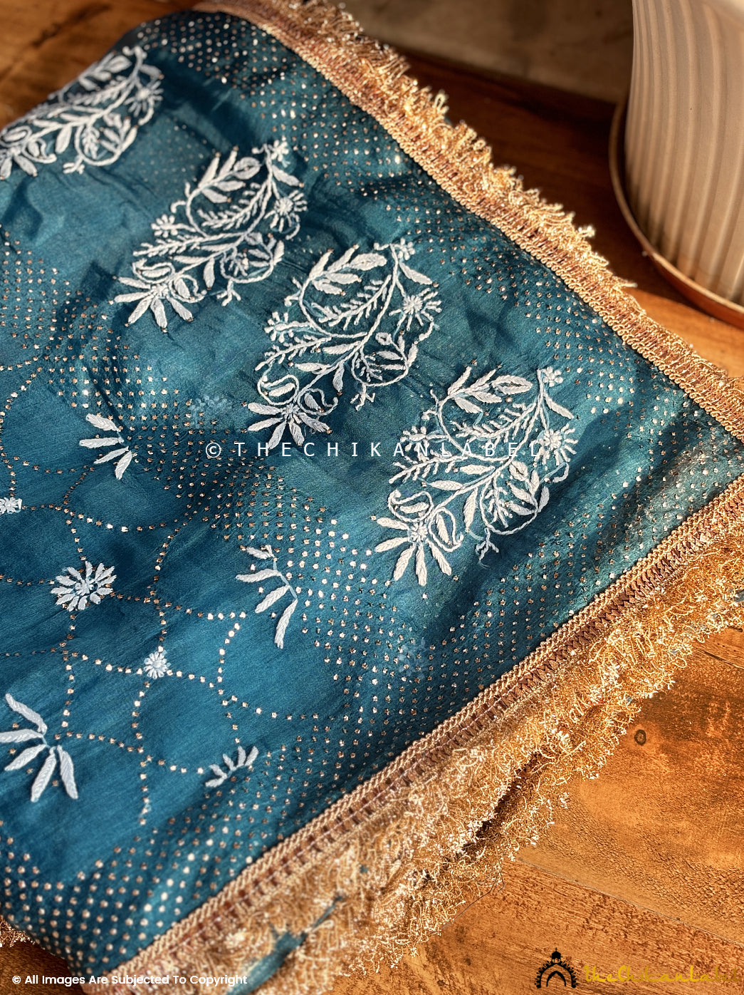 Premium festive wear saree in organza fabric with chikankari embroidery and lace border for a sophisticated ethnic look.