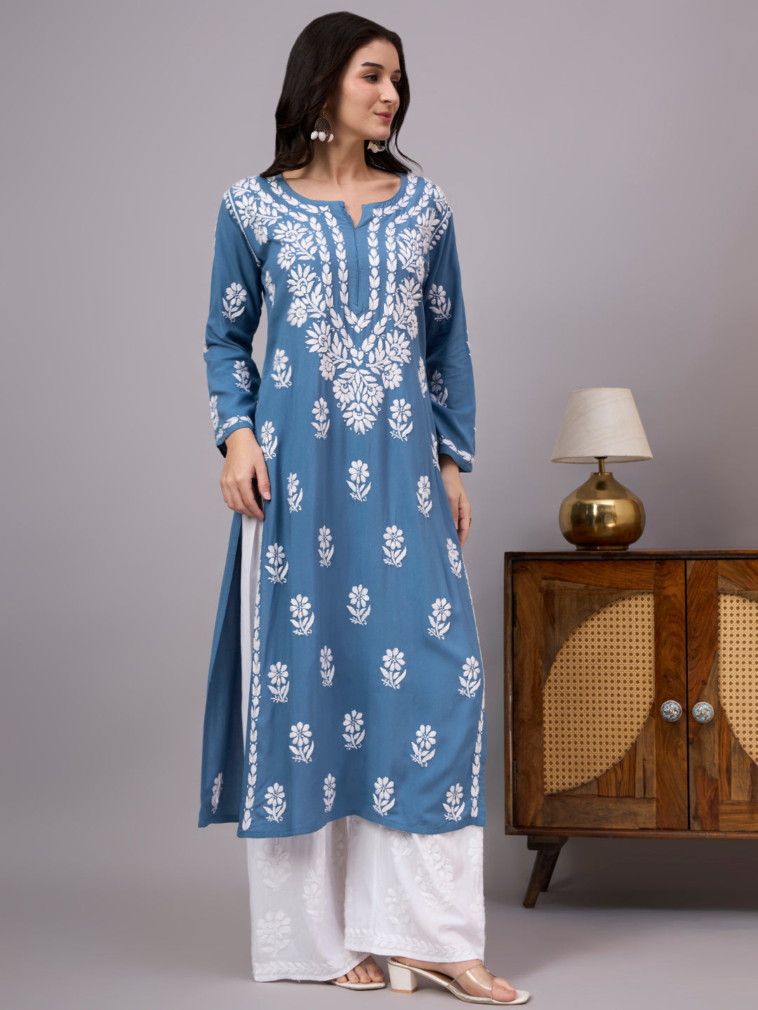 Comfortable regular wear kurti with handcrafted Chikankari embroidery, breathable rayon fabric, classic straight silhouette, and versatile styling for work, travel, and everyday fashion.