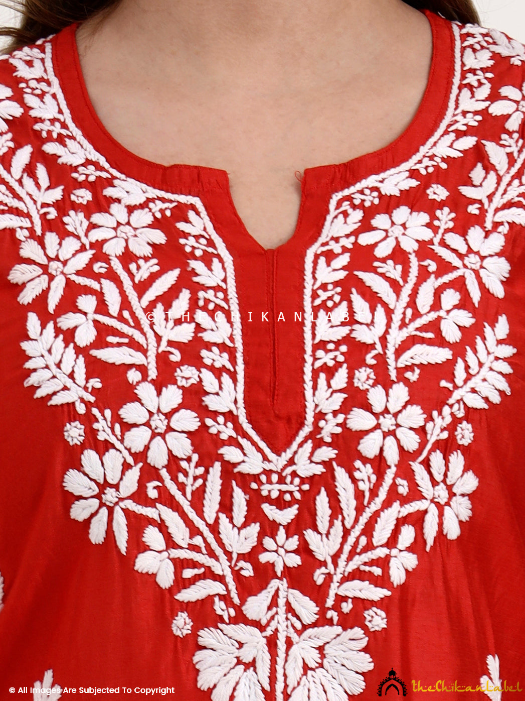 Artisan-made chikankari short kurti in Chanderi fabric featuring traditional embroidery patterns.