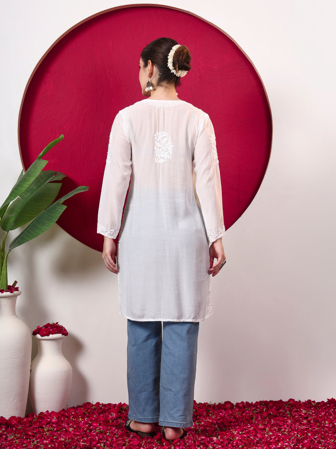 Chikankari kurta for women designed in lightweight muslin fabric with embroidered neckline, floral motifs and a versatile straight-cut silhouette.
