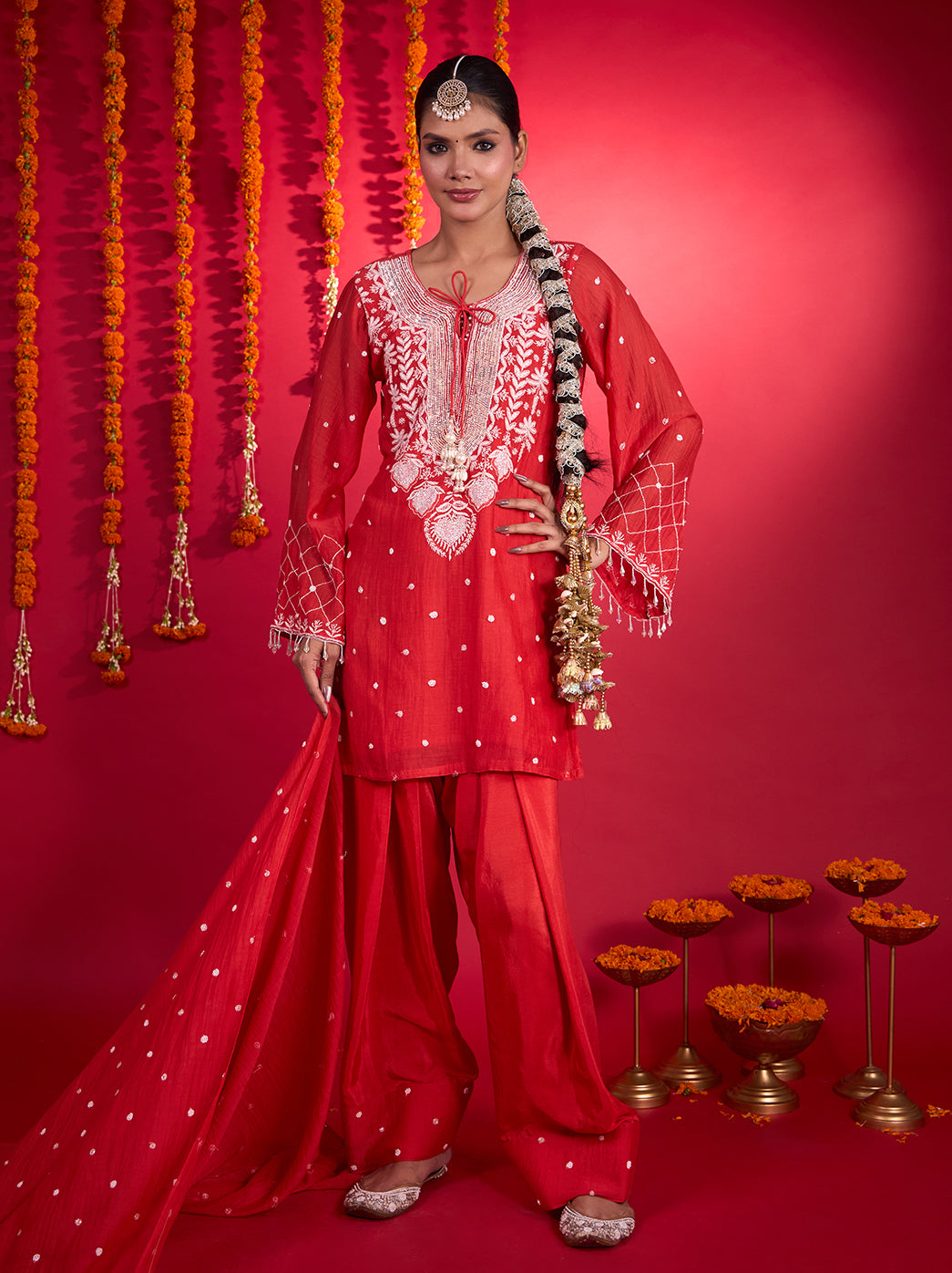 Model wearing the Mehfil-e-Rang Mul Chanderi Kurta Set with Dupatta, featuring floral Chikankari embroidery, full sleeves and flowing wide-leg pants.