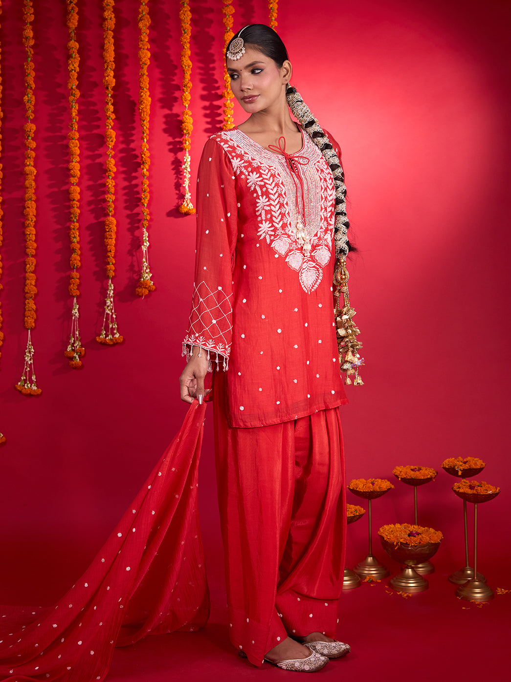 Mehfil-e-Rang Chikankari kurta set featuring a rounded tie-up neckline, decorative tassels and full-length sleeves with flared embroidered cuffs.