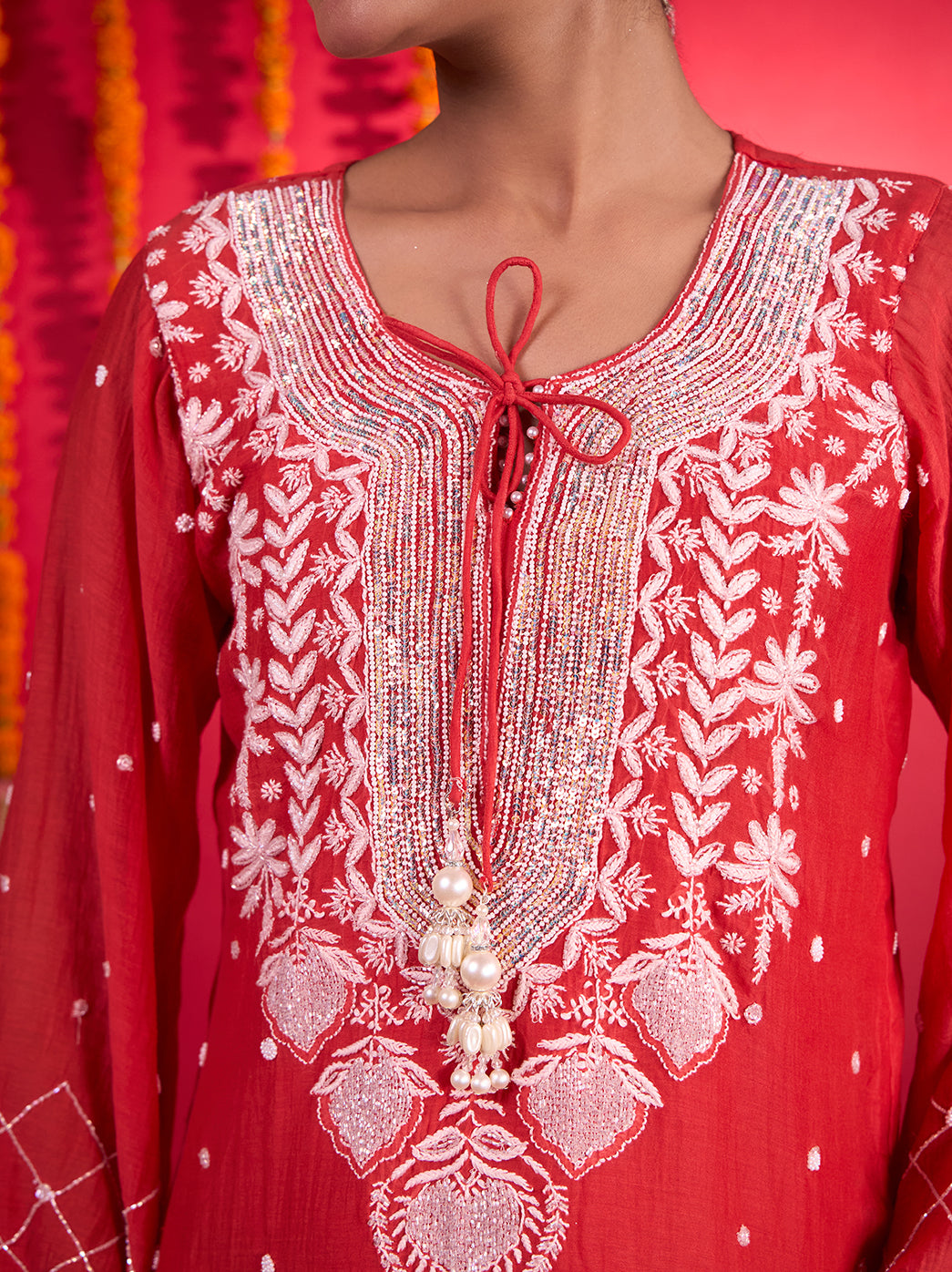Mehfil-e-Rang Mul Chanderi Chikankari kurta set with an embroidered neckline, decorative neck ties and a matching dupatta styled for festive occasions.
