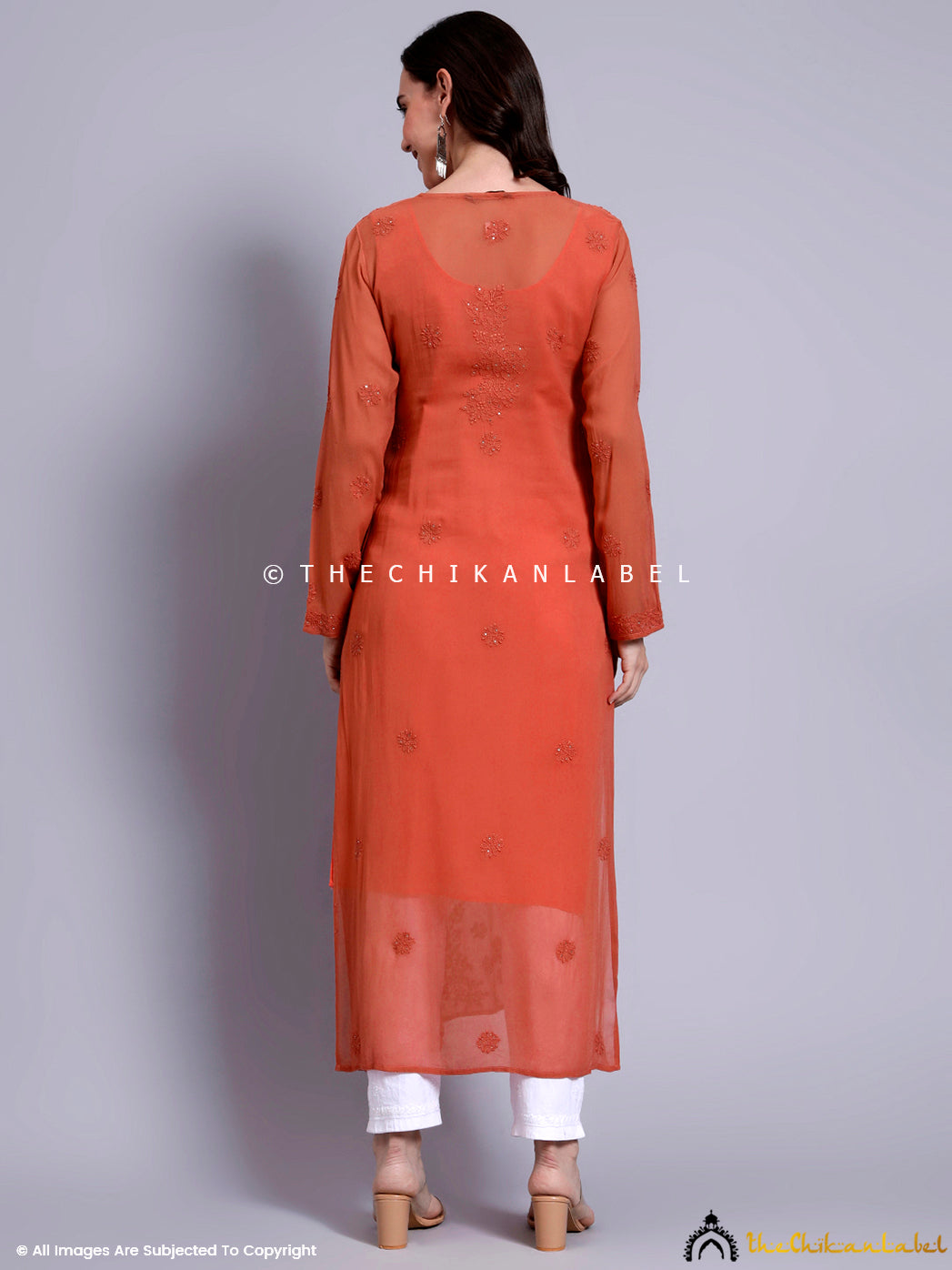 Close-up view of artisan chikankari embroidery with mukaish accents on breathable viscose fabric, worn by a model posing gracefully

