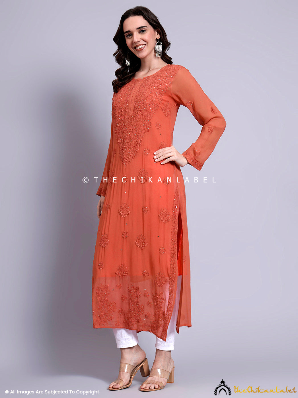 Calf-length straight silhouette kurti with side slits and embellished neckline showcasing handcrafted Indian embroidery work

