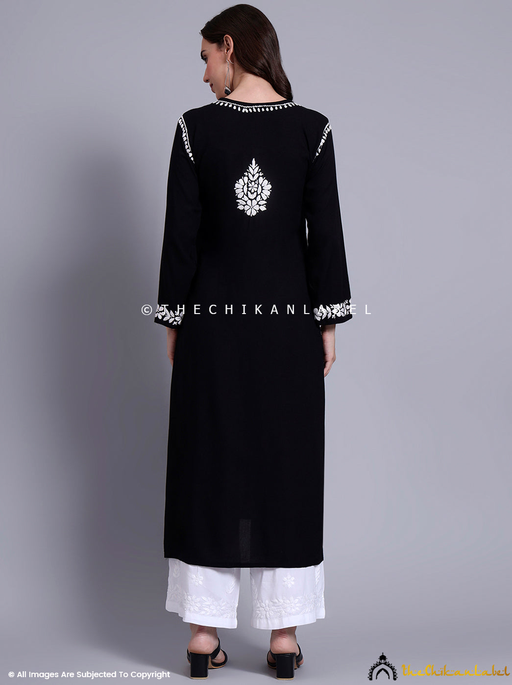 Handcrafted rayon kurti with detailed chikankari embroidery styled with palazzo pants for a graceful ethnic look.

